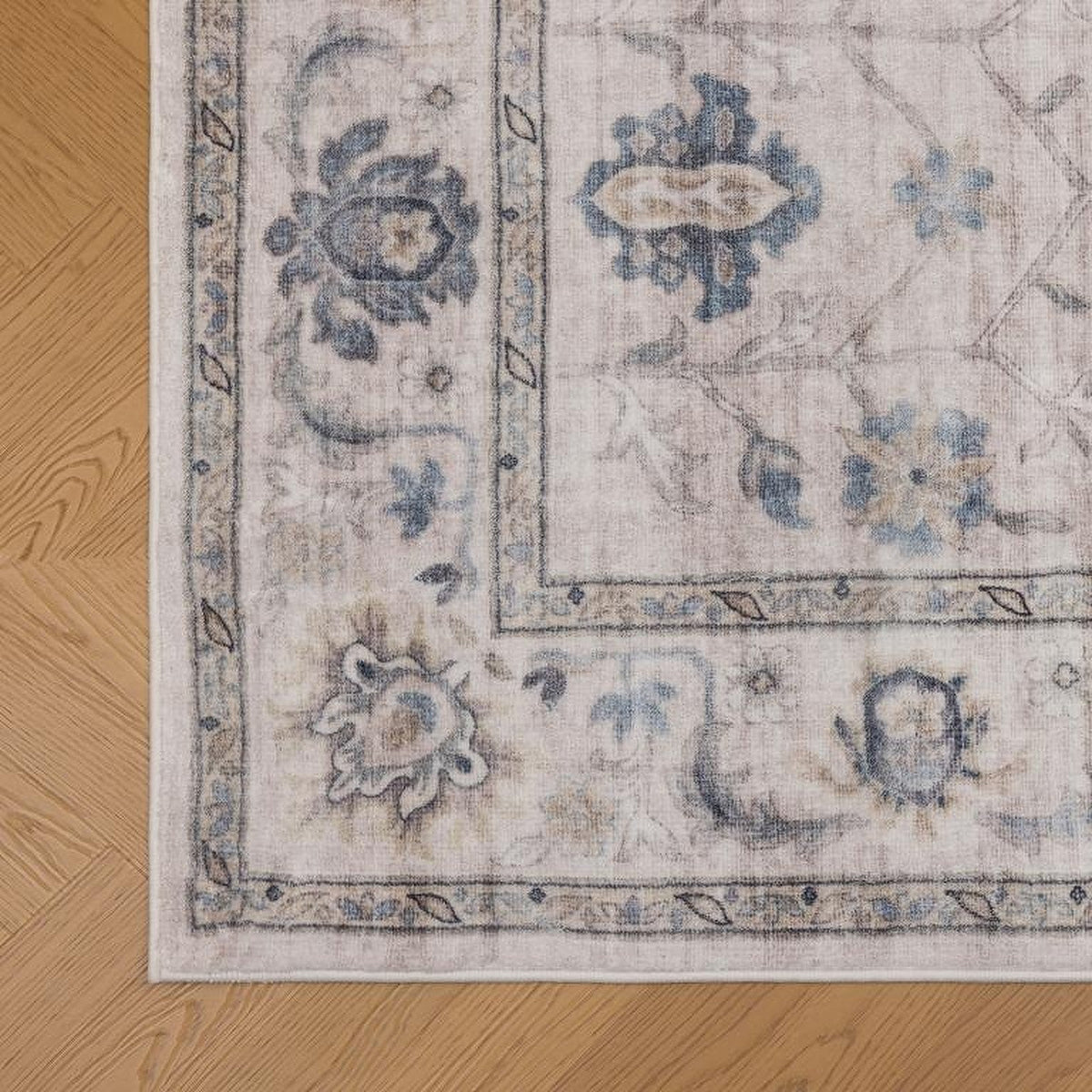 Tapis Albi, coloris beige et bleu, le bord de près