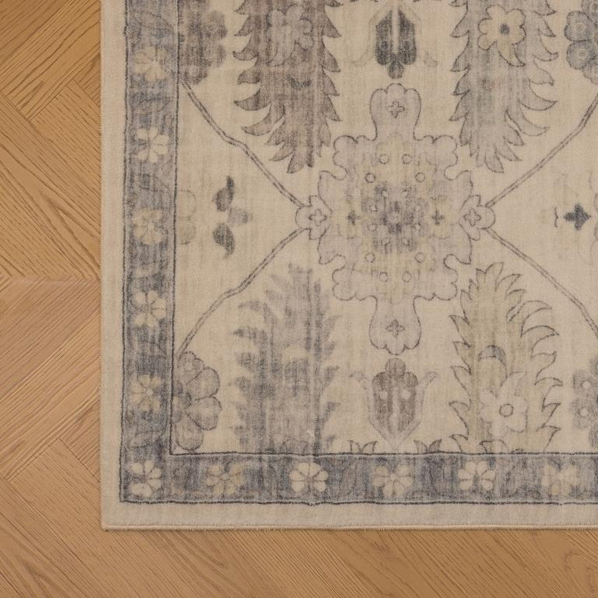 Tapis Moissac, coloris beige et bleu, le bord de près